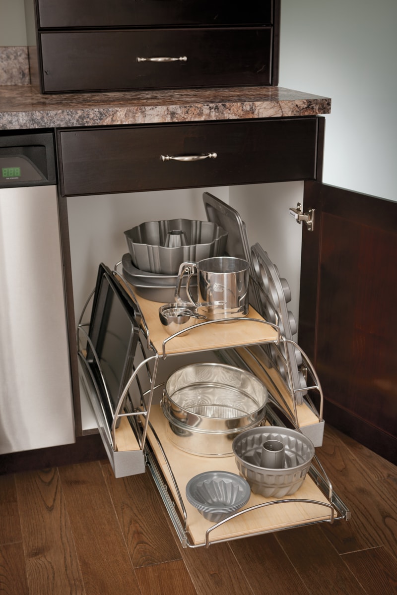 Pull out cabinet shelving filled with bakeware.